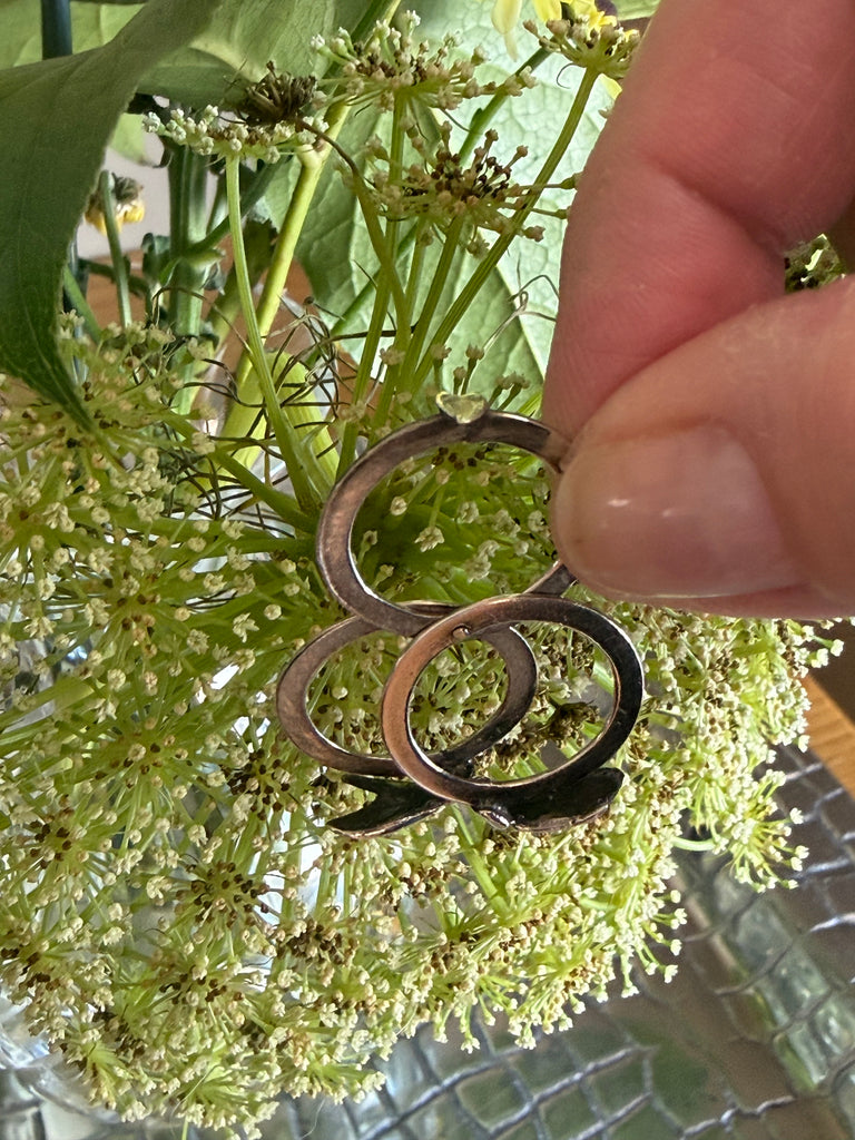 Close-up of vintage sterling silver ring with sculpted holding hands motif