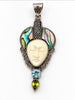 Front of vintage Bali silver pendant with carved face, abalone shell and blue green stones