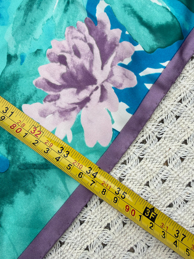 Measuring tape showing the vintage Liberty of London square silk scarf measures approximately 35x35 inches