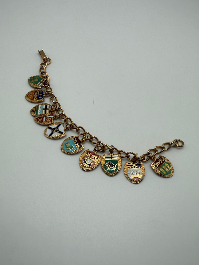 Vintage Canadian gold-tone charm bracelet with ten colourful enamel provincial shield charms