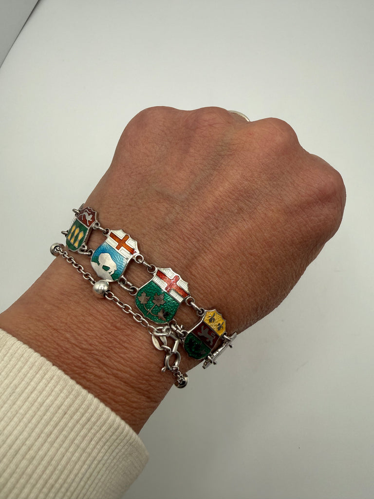 Vintage Canadian enamel shield bracelet in sterling silver shown worn on wrist