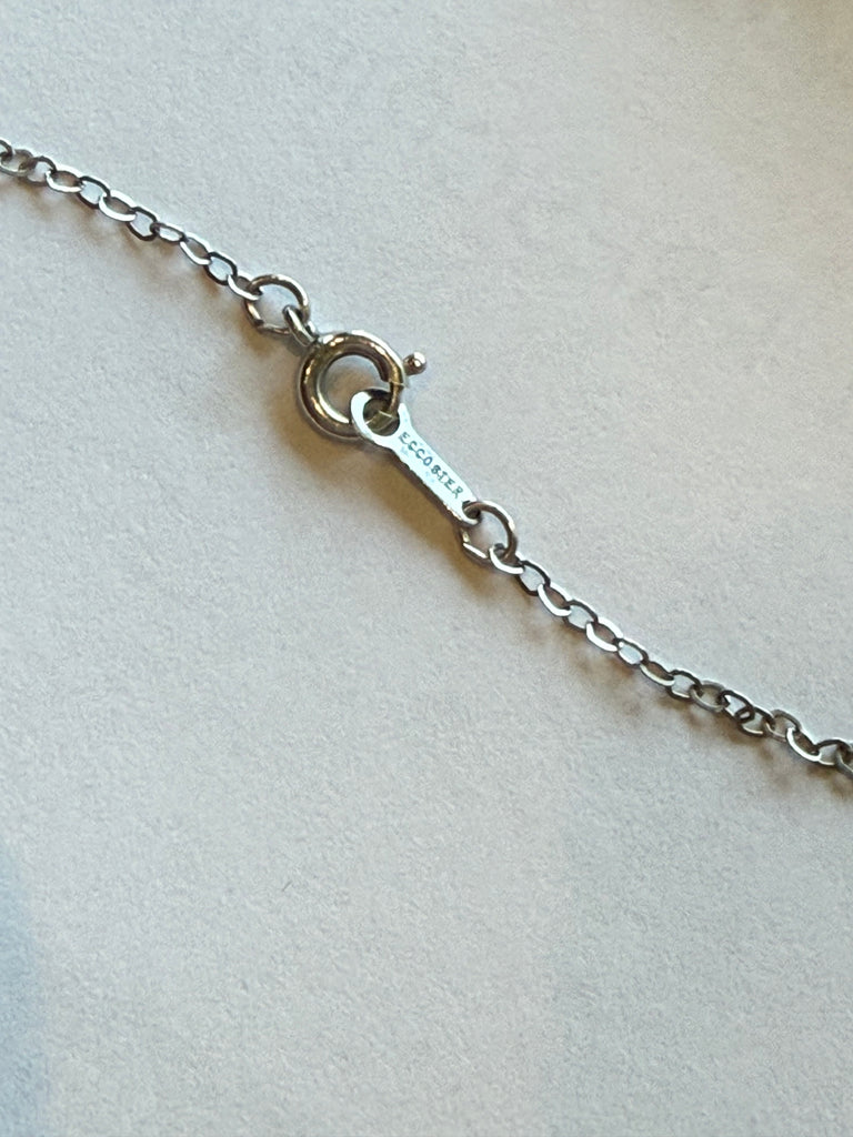 Close-up of ECCO sterling silver pendant hallmark and decorative metalwork
