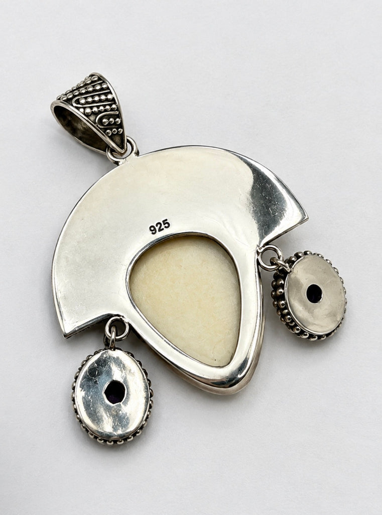 Back of vintage Balinese goddess sterling silver pendant showing silver setting and pendant bail