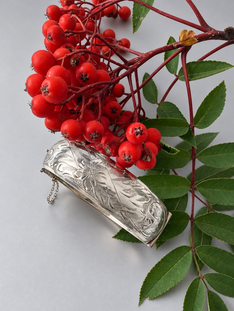 Vintage engraved sterling silver bangle showing floral and scrolling foliage design