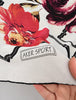 Close-up of Aker Sport scarf showing colourful floral and geometric pattern