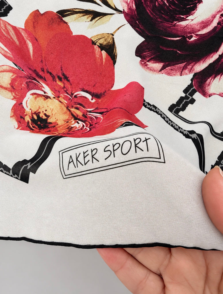 Close-up of Aker Sport scarf showing colourful floral and geometric pattern