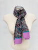 Long vintage Bill Blass silk scarf displayed on a mannequin with pink, teal, purple and grey floral details.