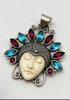 Vintage Balinese Moon Goddess 925 silver pendant with carved face and red and blue gemstone halo