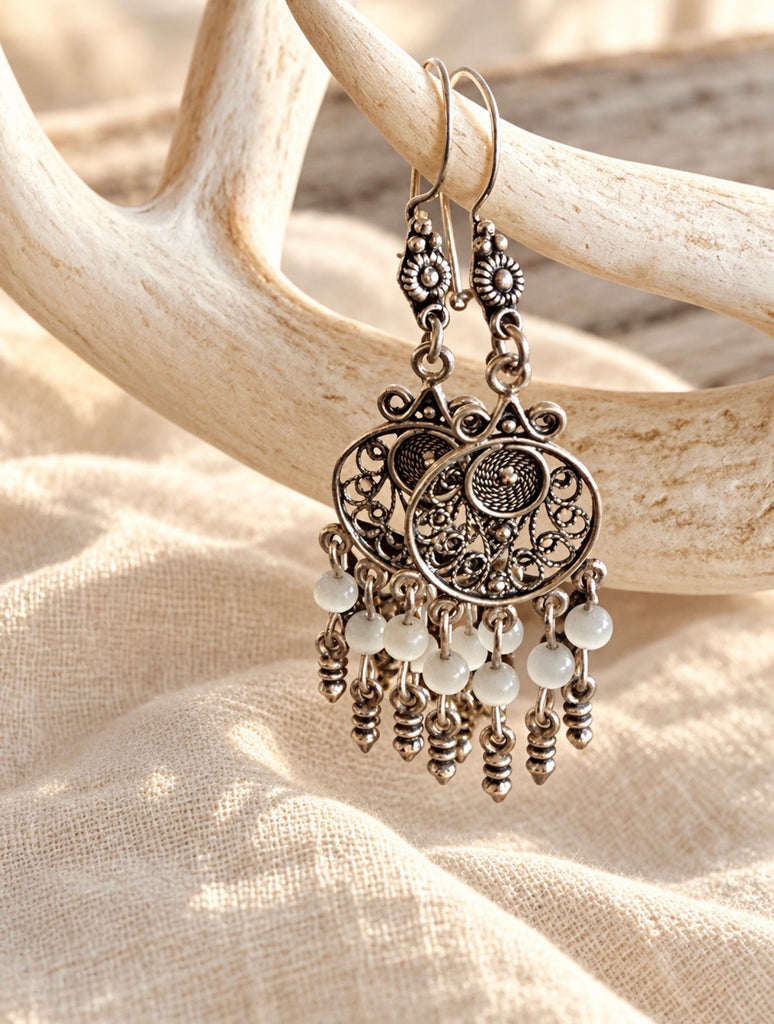 Sterling silver white bead filigree earrings hanging to show movement and detail