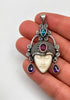 Vintage 925 sterling silver goddess pendant shown in hand with colourful gemstone details