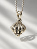 Close-up of LAGOS sterling silver birdcage pendant with sculptural bird detail