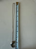 Sterling silver necklace chain photographed beside measuring tape