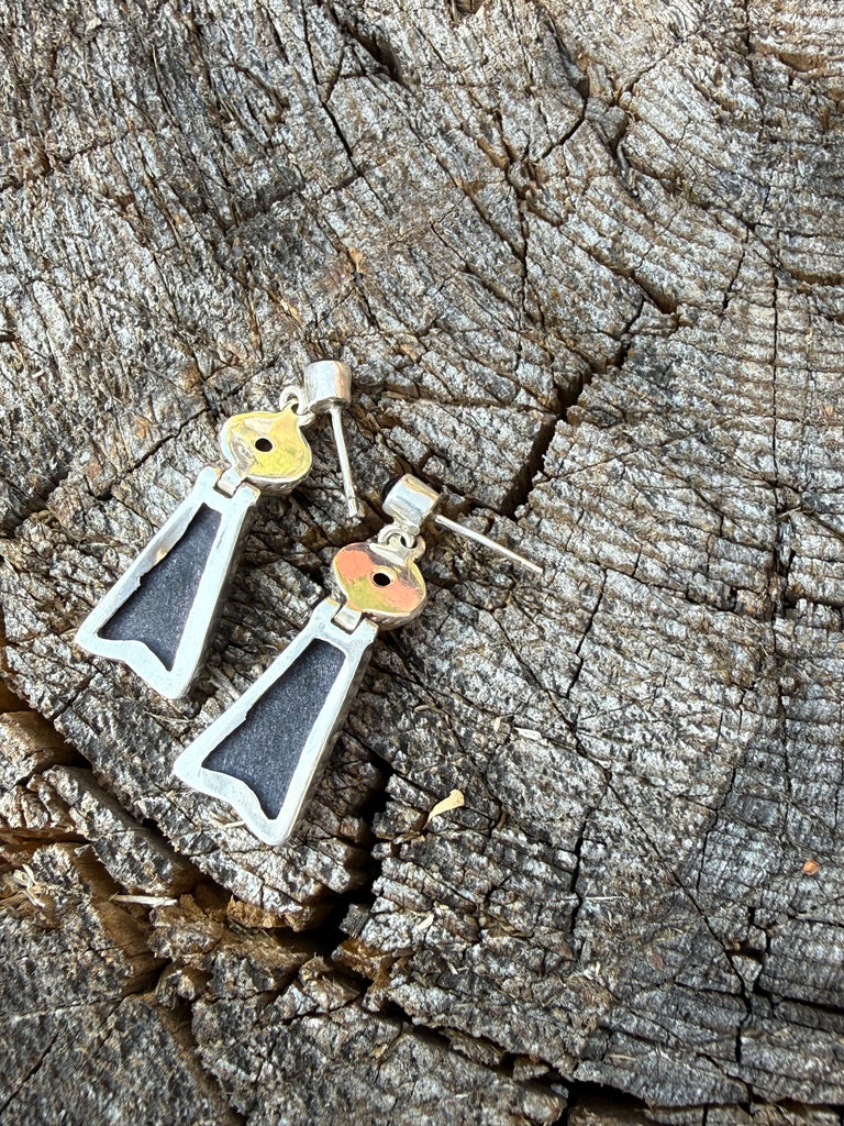 Back view of vintage black onyx earrings showing sterling silver posts and open-back settings