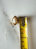 Vintage oval faux pearl jewellery clasp beside measuring tape for size