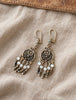 Close-up of 925 sterling silver filigree earrings with dangling silver accents