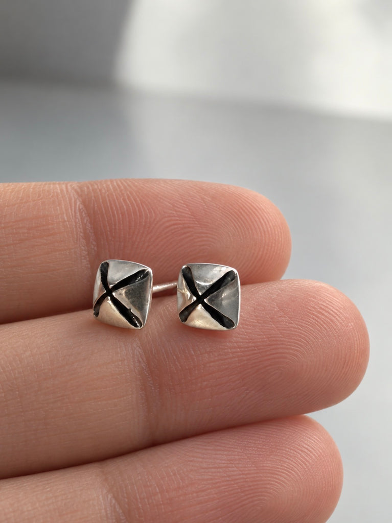 Vintage silver modernist stud earrings held in hand showing size