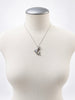 Vintage Ecco dolphin necklace displayed on white mannequin bust