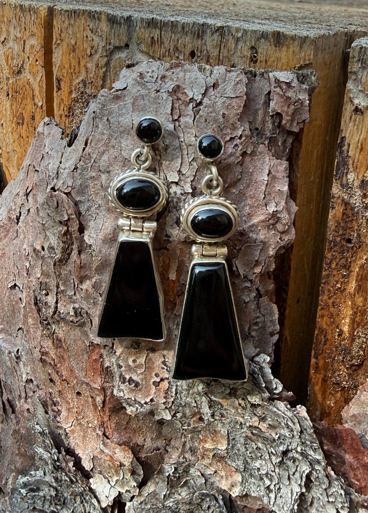 Vintage black onyx sterling silver geometric drop earrings displayed on rustic wood