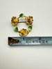 Vintage yellow rose floral brooch beside ruler showing approximately 1.6 inches across
