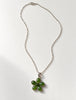 Sterling silver necklace laid flat with green jade floral pendant