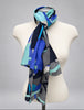 Long blue and aqua Anne Klein silk scarf tied around neck on mannequin