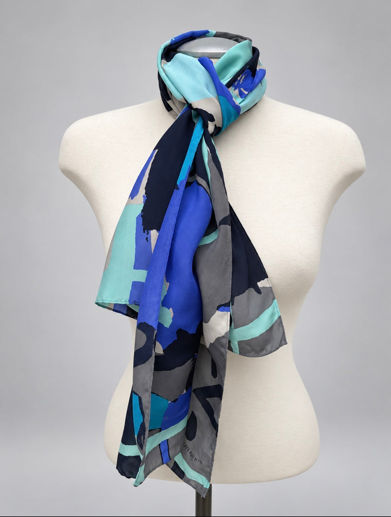Long blue and aqua Anne Klein silk scarf tied around neck on mannequin