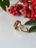 Side view of cognac Baltic amber ring with open gold-plated silver shoulders