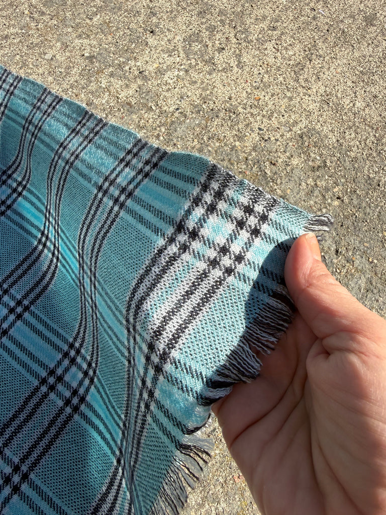 Vintage cashmere silk scarf held in hand showing lightweight fabric
