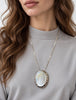 Oval silver mother of pearl pendant necklace styled on model
