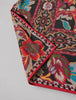 Close-up of richly coloured floral paisley scarf with ornate decorative border