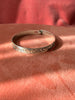 1. Close-up of engraved silver bracelet attributed to Alfred Seaweed