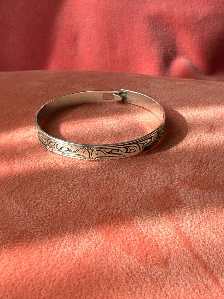1. Close-up of engraved silver bracelet attributed to Alfred Seaweed