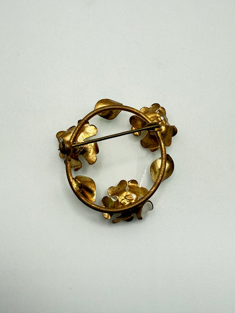 Back view of vintage yellow rose wreath brooch showing gold-tone metal and pin closure