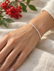 Slim hammered sterling silver bangle bracelet worn on wrist