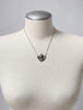 Vintage sterling silver maiden pendant necklace displayed on white jewellery bust