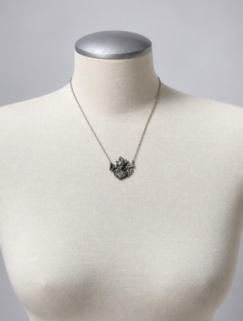 Vintage sterling silver maiden pendant necklace displayed on white jewellery bust
