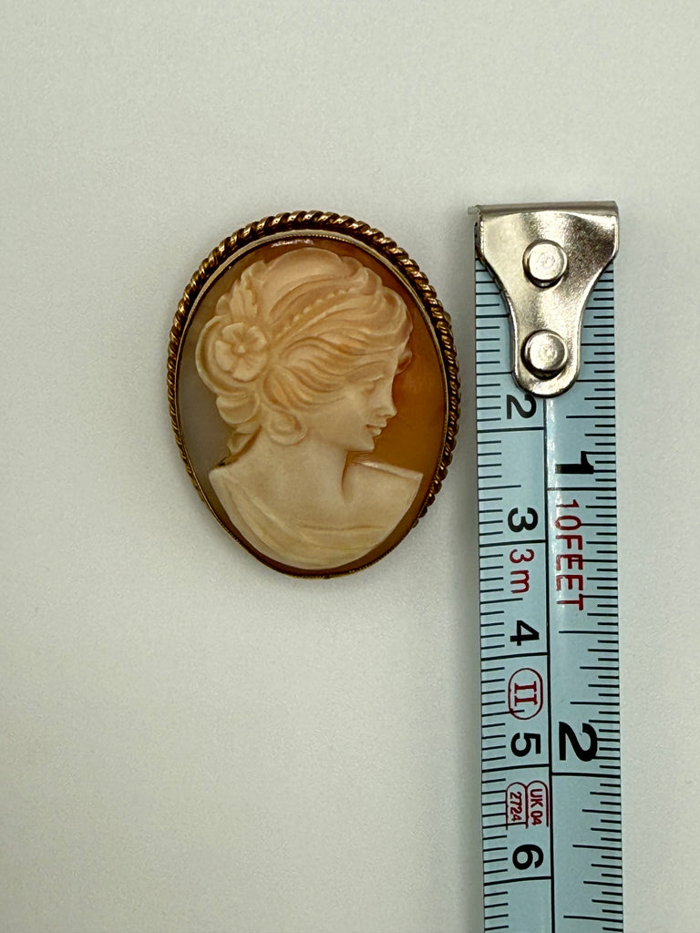 Vintage shell cameo brooch shown beside measuring tape at approximately 3.5 cm tall