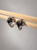 Close-up of oxidized silver lily earrings showing raised flower stamens