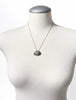 Scandinavian modernist agate pendant necklace displayed on white mannequin