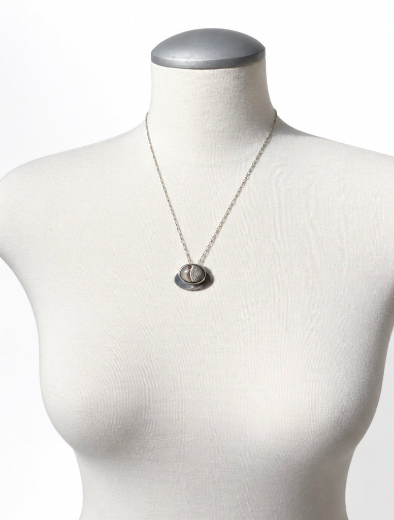 Scandinavian modernist agate pendant necklace displayed on white mannequin