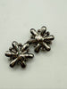 Vintage mid-century black flower earrings displayed together