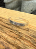 Engraved silver bracelet with Northwest Coast Eagle and Raven formline design