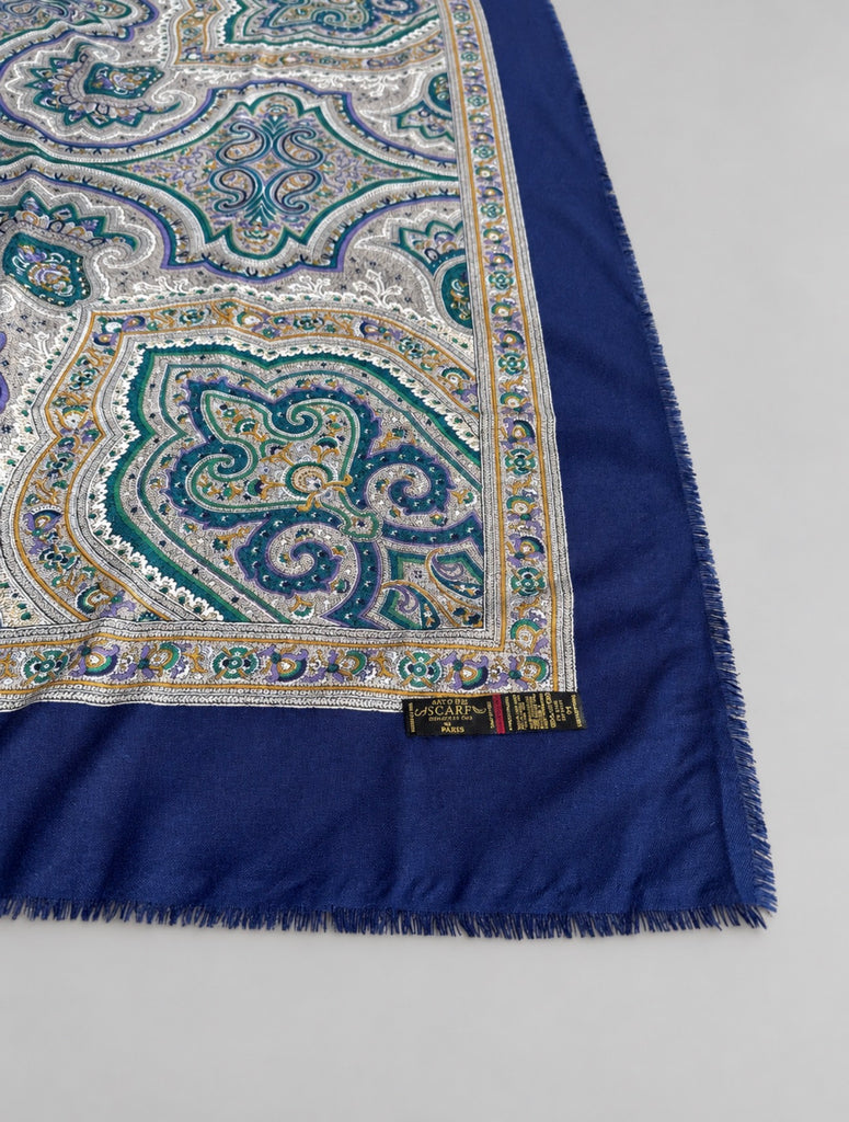 Close-up of ornate teal cream and blue paisley medallion pattern