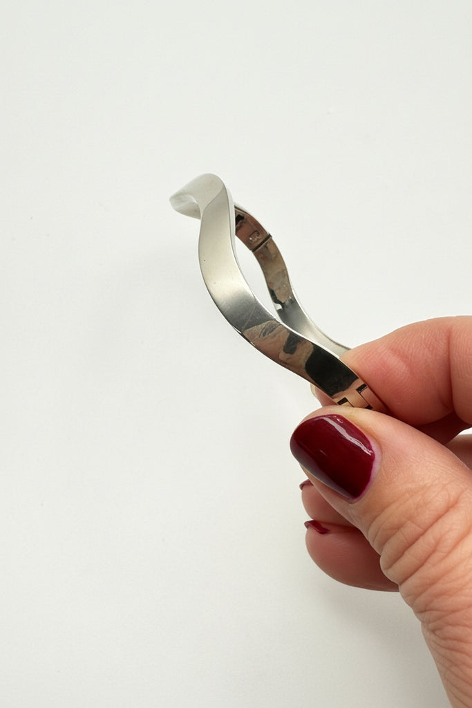 Vintage Mexican 925 sterling silver hinged bangle with sculptural squared shape shown in hand