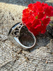 Side view of vintage black onyx ring showing decorative sterling silver openwork setting