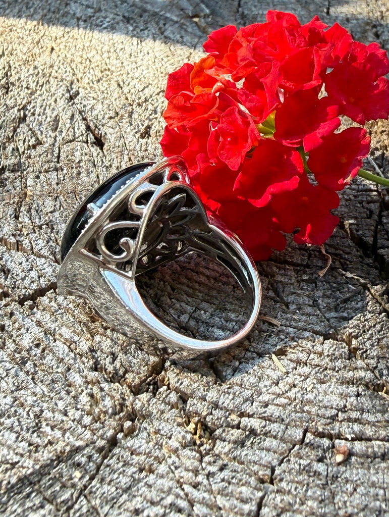 Side view of vintage black onyx ring showing decorative sterling silver openwork setting