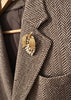 Vintage gold-tone grape brooch with cream faux pearls worn on blazer