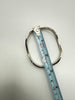 Vintage 925 silver bangle beside measuring tape showing bracelet dimensions