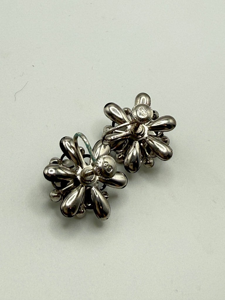 Back view of vintage flower earrings showing adjustable screw back closures