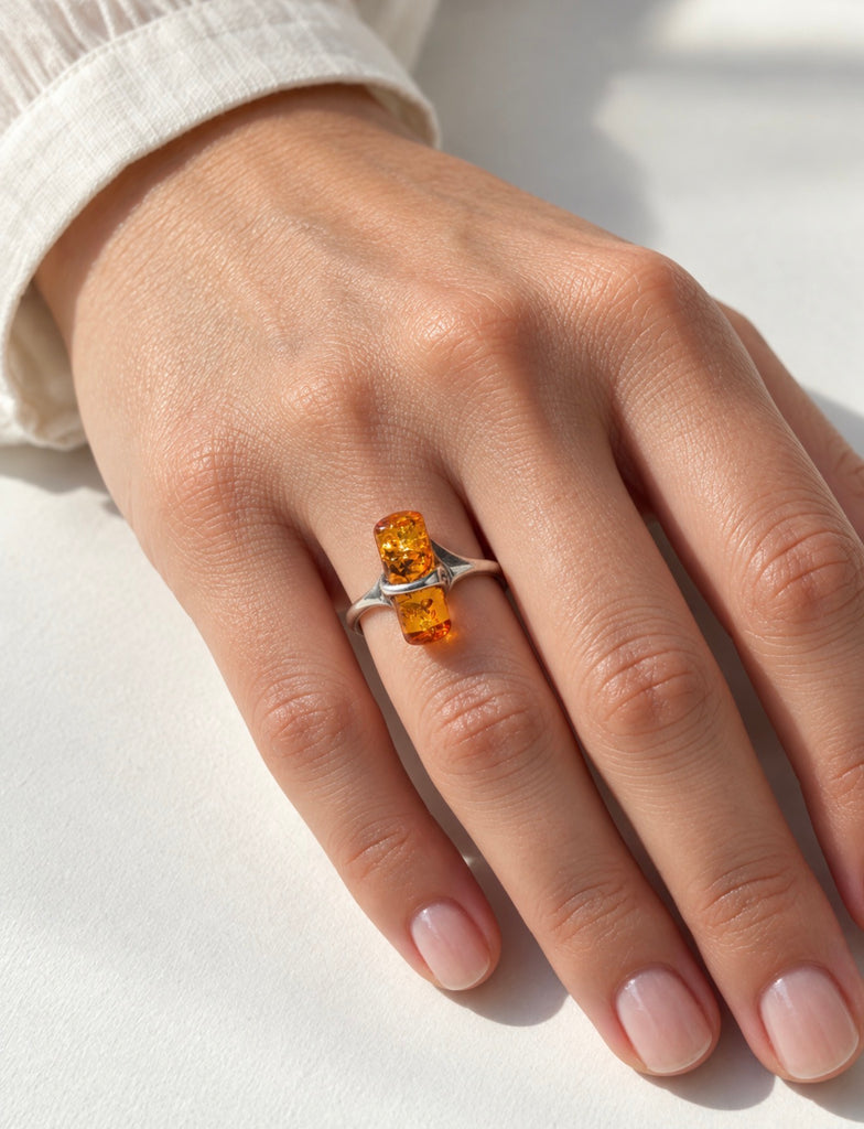 Scandinavian-inspired amber silver ring worn on hand showing minimalist design